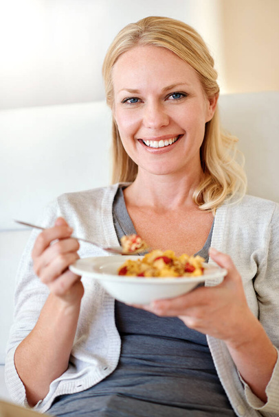 Its as delicious as it looks. Portrait of a woman enjoying breakfast at home - Foto, Imagen