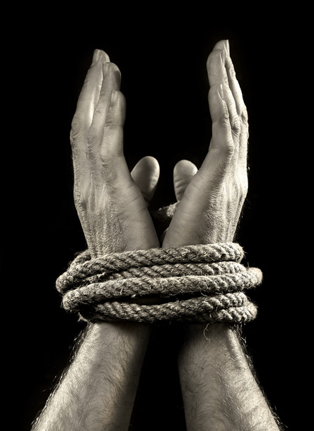 white man hands wrapped with rope around wrists in victim abused in captivity, slave of work and respect for human rights concept - Photo, Image