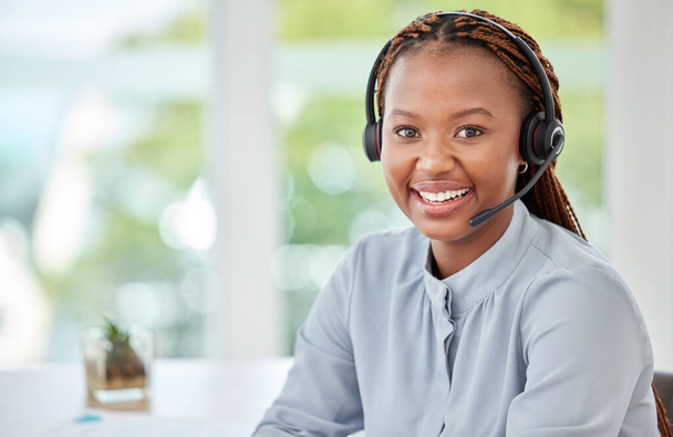 Portrait of a black customer support consultant, receptionist or call center agent with a headset. Happy, expert and professional woman employee working in ecommerce at a telemarketing company - Photo, Image