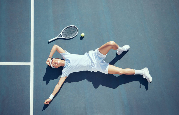 Tired tennis player, sports burnout and game fatigue on court sport training, muscle injury from exercise on ground and sad about mistake. Depressed and Asian athlete upset about competition loss. - Zdjęcie, obraz