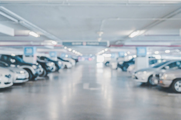 Abstract blur image of Many cars in parking garage interior at department store or shopping mall , industrial building for banner advertising background - Fotografie, Obrázek