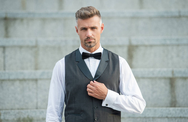 elegant groomsman in bowtie. grizzled businessman in formalwear. tux businessman in suit. - Foto, imagen
