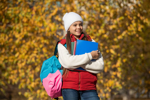 cheerful teen girl back to school in autumn. - Foto, imagen