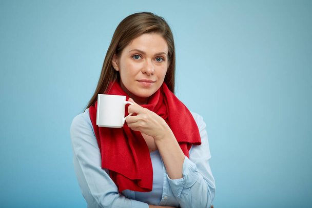 Woman holding white mug. sick girl in red scarf. isolated female portrait. - Fotoğraf, Görsel