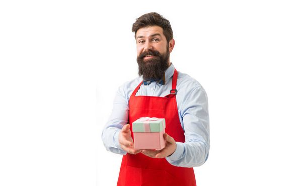 Happy man in cook apron holding present box. Cook smiling with birthday present studio. Present from chef. Gift for restaurant owner. - Foto, imagen