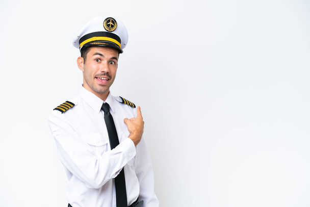 Airplane pilot over isolated white background pointing back - Photo, image