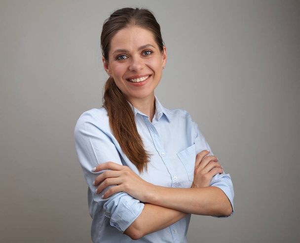 Smiling young woman with long hair wearing blue shirt standing with crossed arms.isolated female portrait. - Φωτογραφία, εικόνα
