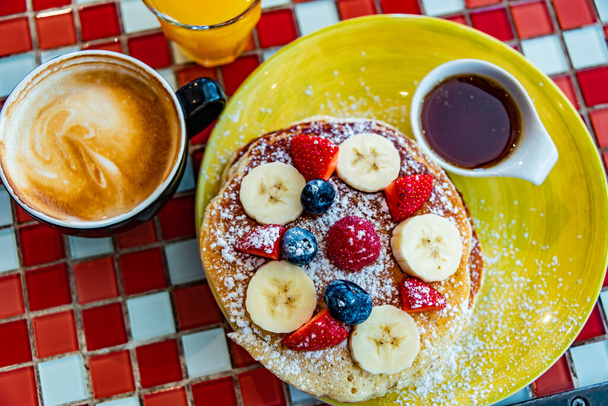 Belgian pancakes served with fruits and maple syrup. - Photo, image