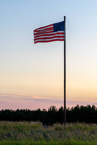 American flag against an evening sky, dusk, sunset,  in Minnesota, USA - Photo, Image
