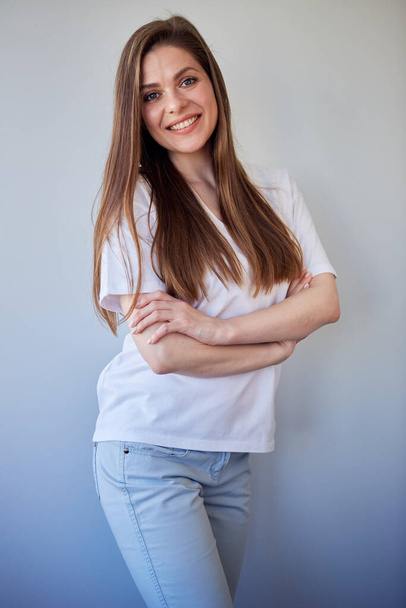 Smiling woman in white shirt portrait with crossed arms. Happy girl with long brown hair. - Valokuva, kuva
