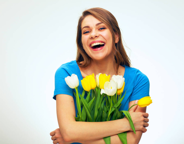 Laughing woman holding flowers bouquet. isolated female person portrait. - Fotó, kép