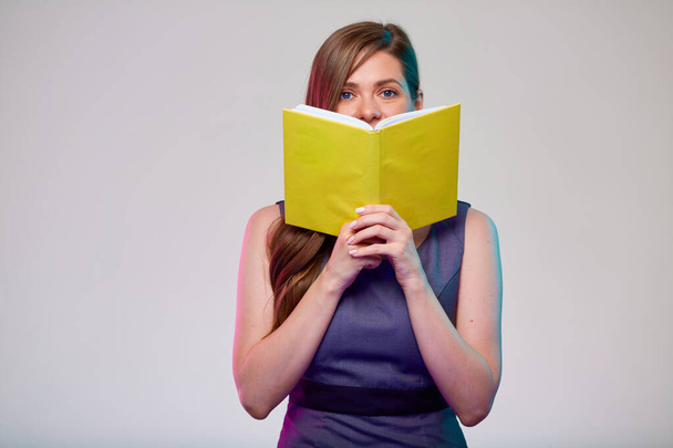 Teacher or smiling  woman adult student holding open yellow book in front of, isolated portrait. - Foto, Imagem
