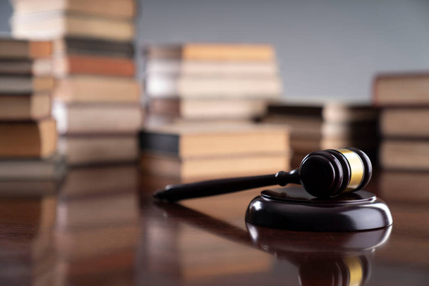 Law theme - judge office. Gavel and legal books on the judge desk.  - Foto, imagen