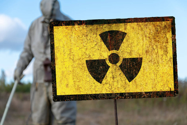 Altes strukturelles Zeichen für Strahlengefahr, militärische chemische Aufklärung misst die Strahlenbelastung vor dem Hintergrund kontaminierter Natur. - Foto, Bild