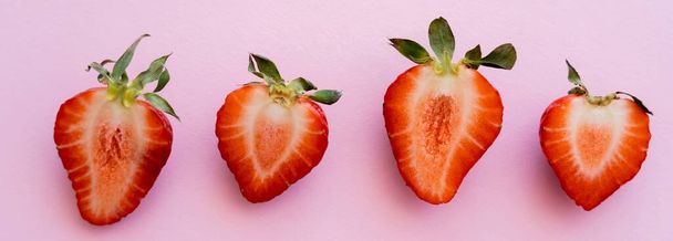 flat lay of red sliced strawberries in row isolated on pink with copy space, banner - Zdjęcie, obraz