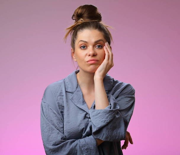 Boring woman wearing pajama, isolated on pink background, female face portrait - Foto, imagen