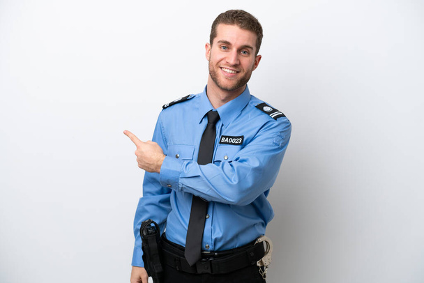 Young police caucasian man isolated on white background pointing back - Fotografie, Obrázek