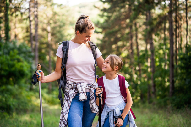Mother and daughter enjoy hiking together. - Фото, зображення
