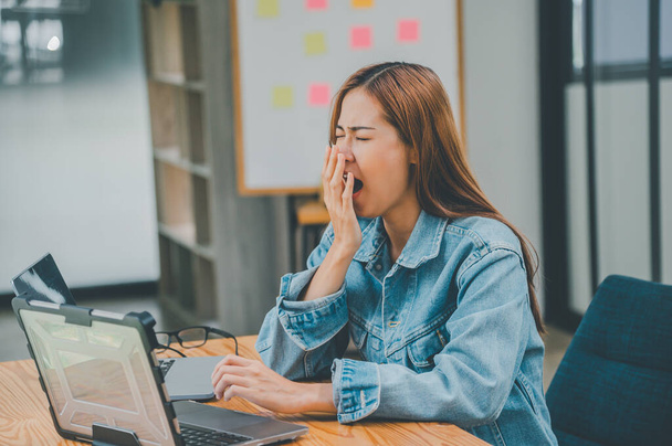Female programmers are sleepy and exhausted after working and planning to work on programming, software coding and web design. Concept technology development. - Photo, Image