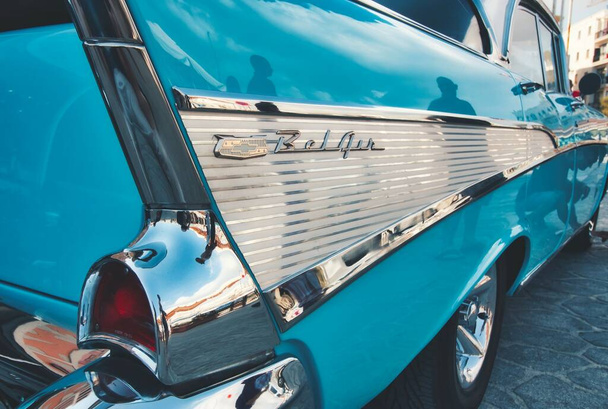 Closeup of the rear side of an aqua marine blue 1957 Chevrolet Bel Air with bullet bumper guards - Photo, Image