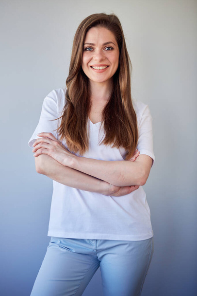 Smiling woman in white shirt portrait with crossed arms. Happy girl in white casual clothes. - Fotografie, Obrázek