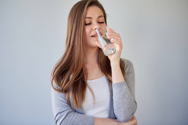 Woman drink water and looking away. isolated portrait. - Photo, Image