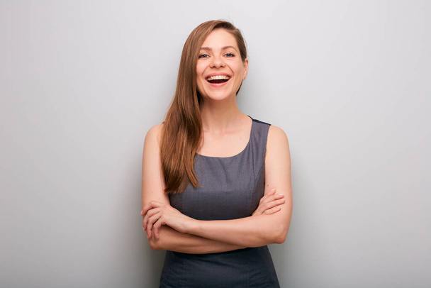 Happy business woman in dress with crossed arms. isolated female business person portrait. Mouth open, whide smile. - Foto, Imagen