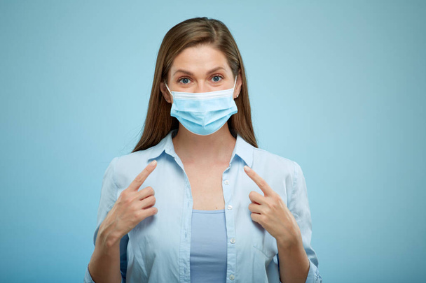 Young Woman wearing medical anti virus mask. isolated female portrait portrait. pointing finger on mask. - Foto, Bild