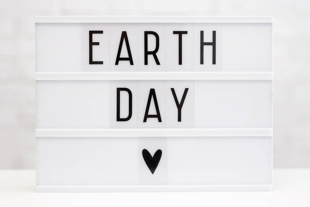 Earth day concept - lightbox with earth day words on the table - Фото, зображення