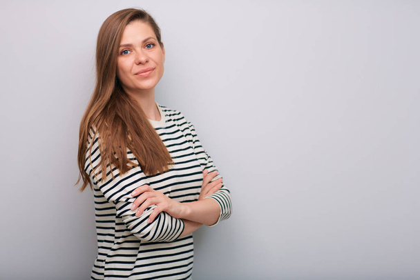 Young smiling woman in striped shirt with crossed arms isolated portrait   - Foto, Imagen