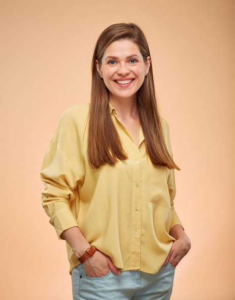 Smiling woman isolated portrait on yellow background. Young lady with long hair wearing casual shirt. - Φωτογραφία, εικόνα