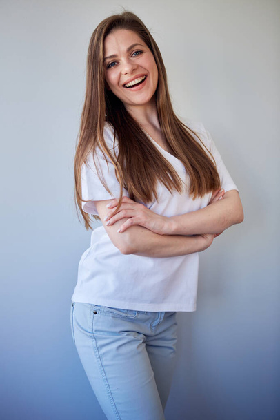 Smiling woman in white shirt portrait with crossed arms. Happy girl in white casual clothes. - Photo, Image