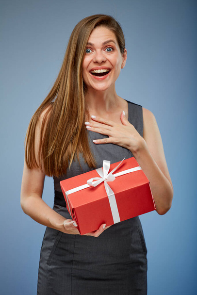 Surprising woman with red gift box studio isolated portrait on blue. - Foto, Bild