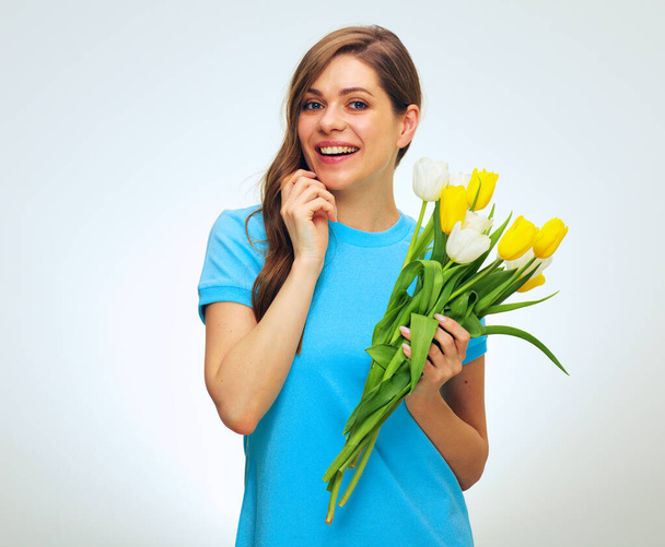 Happy woman with big toothy smile holding tulip flowers. isolated female studio portrait. - Foto, Imagem
