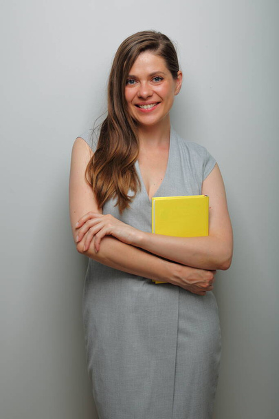 Happy teacher woman or student, business woman with yellow book isolated female portrait.   - Foto, immagini