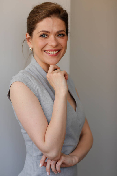 Happy woman in business dress on gray wall background. - Fotó, kép