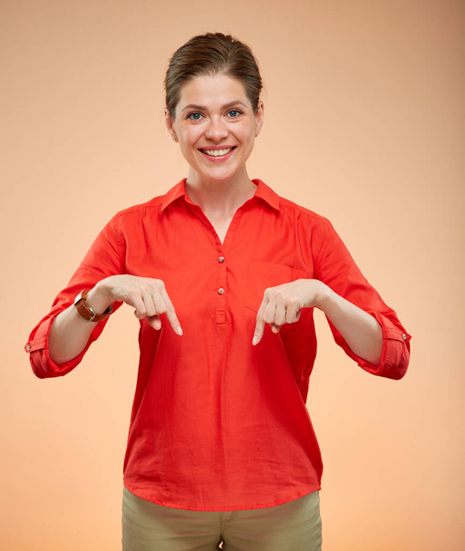 Isolated portrait of smiling business woman pointing fingers down. - Fotoğraf, Görsel