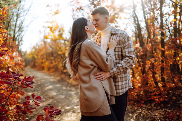 Stylish couple walking and enjoying autumn weather. People, lifestyle, relaxation and vacations concept. Autumn Fashion, style concept. - Photo, image