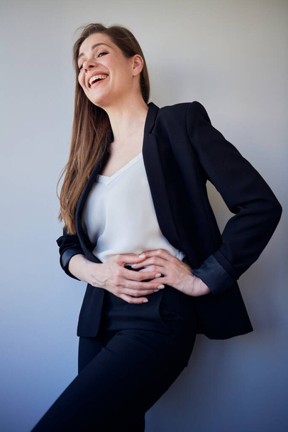 Laughing woman in black business suit and white shirt keep hands on hips. isolated portrait girl looking away.. - Foto, Imagem