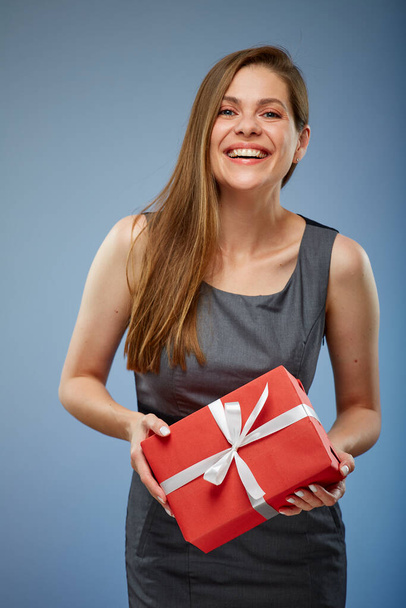 Happy business woman with red gift box studio isolated portrait on blue. - Foto, Imagen
