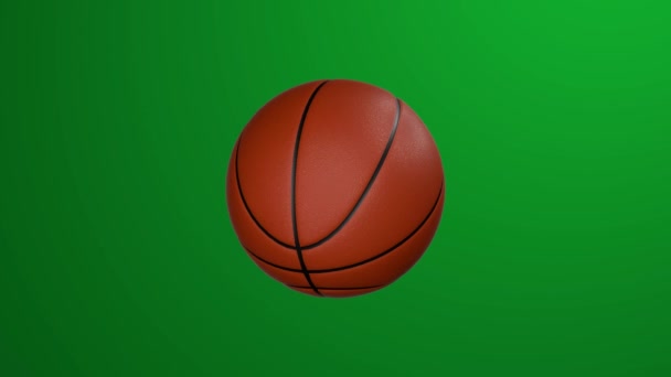 Klasický basketbal rotuje na zeleném pozadí. Klíč Chroma. - Záběry, video