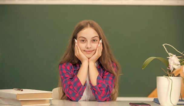 child ready to study. teen girl smile back to school. knowledge day. education concept. kid in classroom on blackboard background. september 1. childhood. - Photo, Image