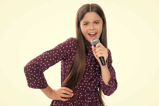Teenager singing with a microphone. Karaoke singer. Teen girl sings. Child girl musician loud voice. - Photo, Image