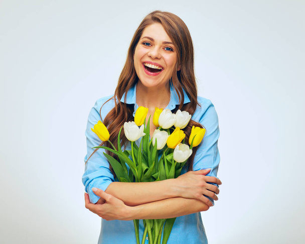 Laughing woman holding flowers bouquet. isolated female person portrait. - Fotó, kép