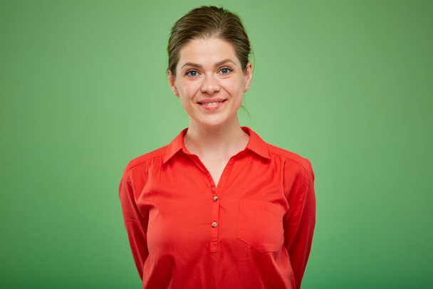 Smiling young lady in red shirt isolated portrait on green studio background. - Foto, Imagem