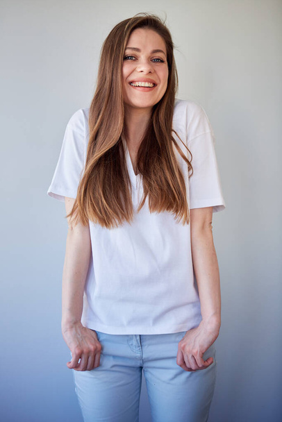 Smiling woman in white shirt. Happy girl with long hair. - 写真・画像