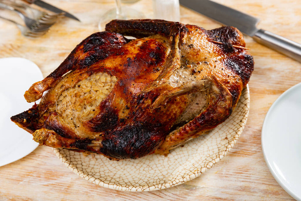 Rustic style whole roasted goose stuffed with barley served on plate - Photo, Image