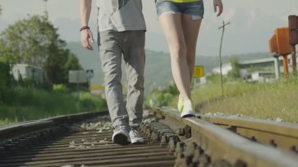 Couple walking on railroad tracks - Footage, Video