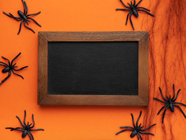 Halloween holiday background with  decorations.  Halloween background with spider web and spiders as symbols of Halloween. View from above. Flat lay - Zdjęcie, obraz