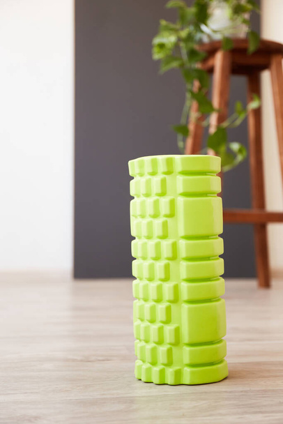 Green MFR sport roller for self-massage. Home fitness accessories. Flexibility and mobility, body strength - Foto, Imagem